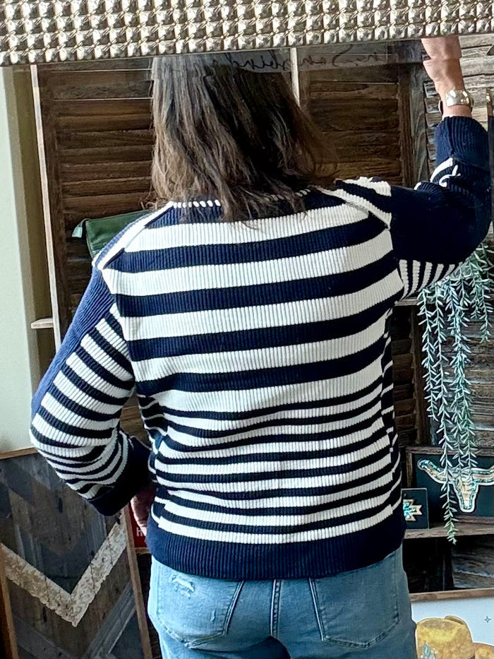Navy and white striped knit sweater with crew neck and long sleeves, back view