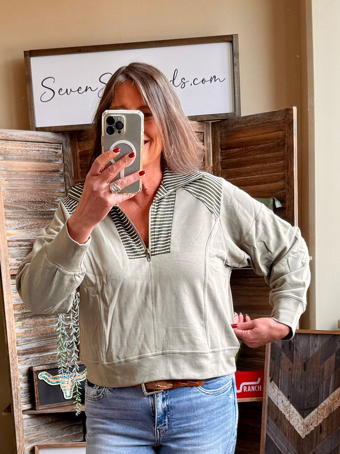 Light olive quarter-zip sweatshirt with ribbed striped collar and long sleeves