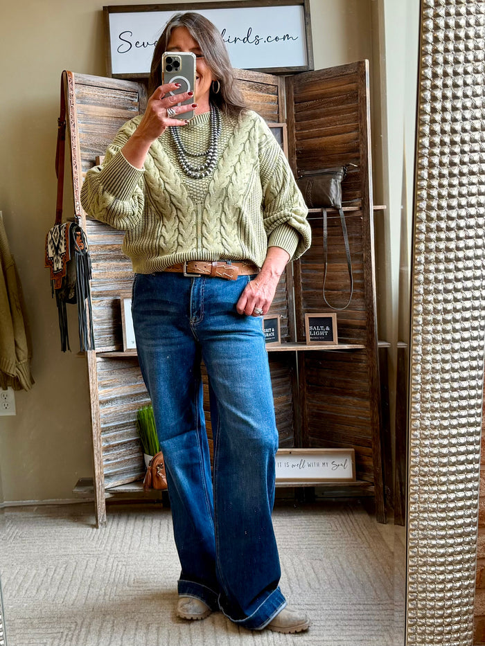 Olive cable-knit sweater with textured cable front and ribbed cuffs and hem