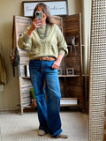 Olive cable-knit sweater with textured cable front and ribbed cuffs and hem