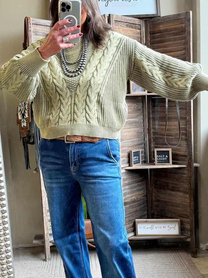 Olive cable-knit sweater with long sleeves, ribbed hem, and crew neckline