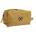 The Pony Rider Slow Road Waxed Canvas Toiletry Bag in Clay is a brown canvas grooming bag featuring a simple black logo with crossed lines and the letters "P" and "R." It includes a convenient handle zip closure and is made in India.