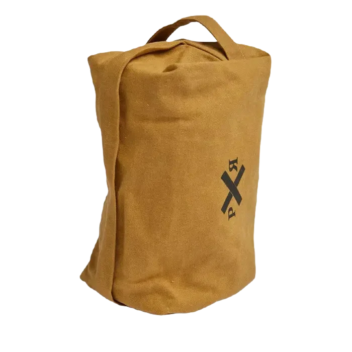 The Pony Rider Slow Road Waxed Canvas Toiletry Bag in Clay is standing upright, showcasing a black crossed arrows graphic on its tan canvas front. It features a short handle at the top and a secure zip closure. Made in India, this versatile piece can double as a stylish grooming bag.