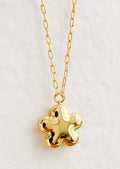 A flower shaped necklace in gold with a puffy look.