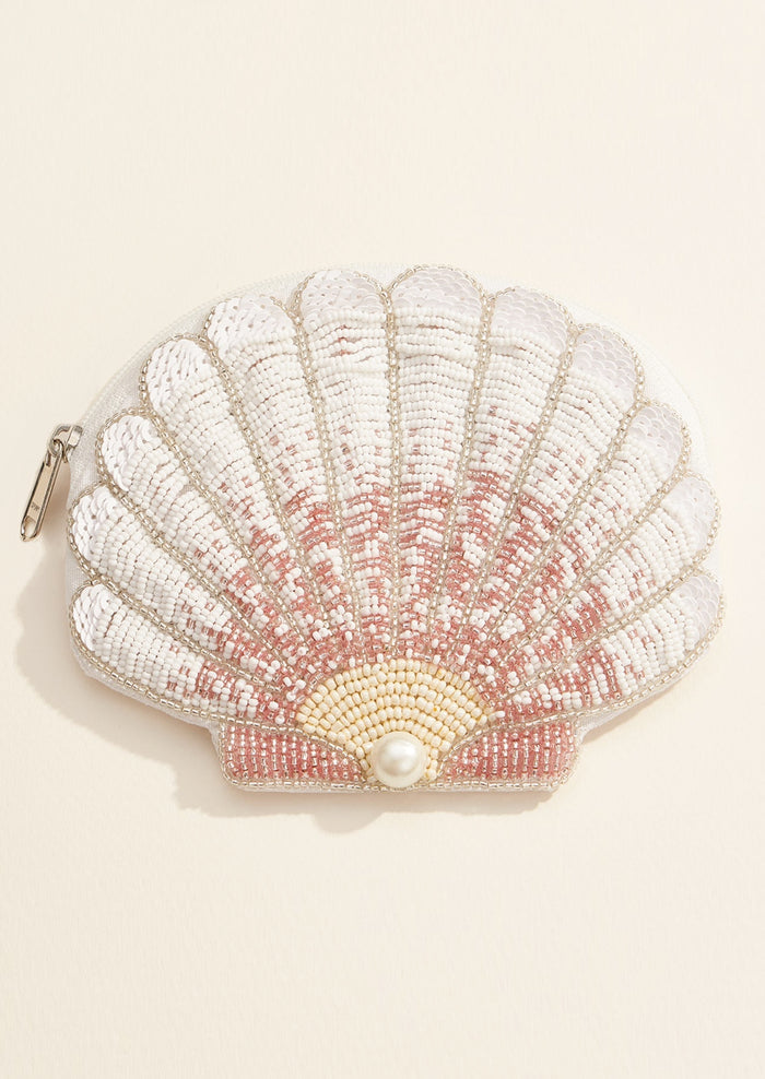 Shell-shaped pouch with beading and a pearl on a beige background