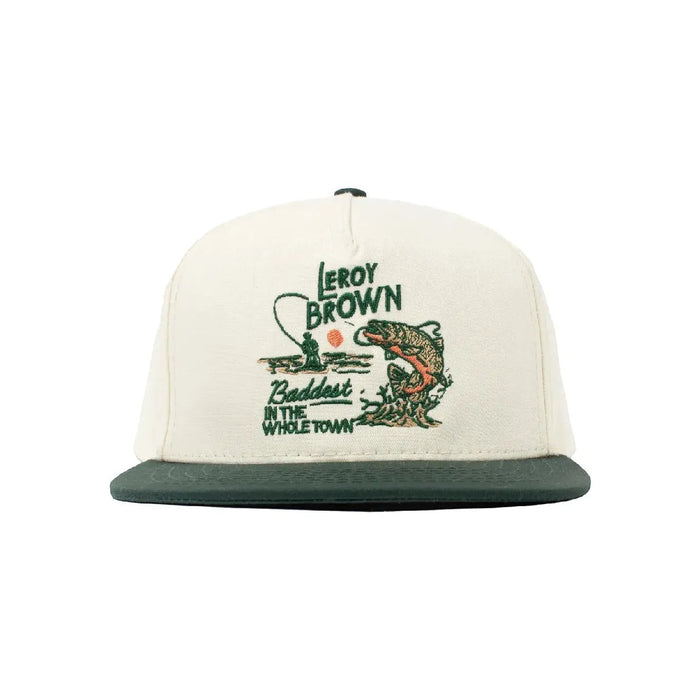 Introducing the Sendero Provisions LeRoy Brown Cap: a beige and green cotton canvas hat featuring an embroidered design of a fish, a fishing rod, and the text "Leroy Brown Baddest in the Whole Town." Expertly crafted in Mexico with premium print quality.