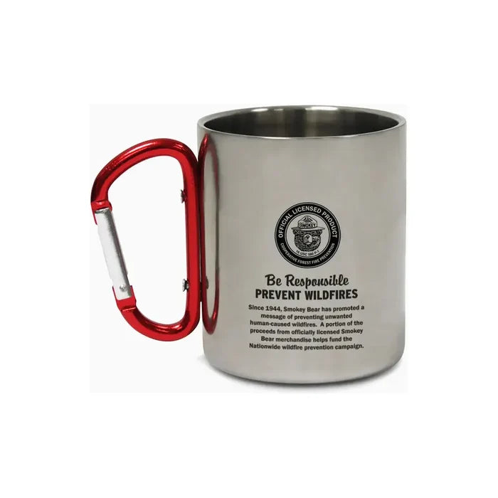 The Smokey Bear Carabiner Handle Mug - Waving Smokey is a silver mug that showcases an illustration of Smokey Bear wearing a ranger hat, featuring a vibrant red carabiner handle to promote wildfire prevention.