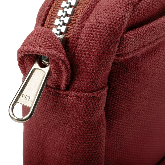 Maroon Soolla® Studio Artist Stationery Pouch in Sangria shade, close-up with silver YKK zipper partially unzipped.
