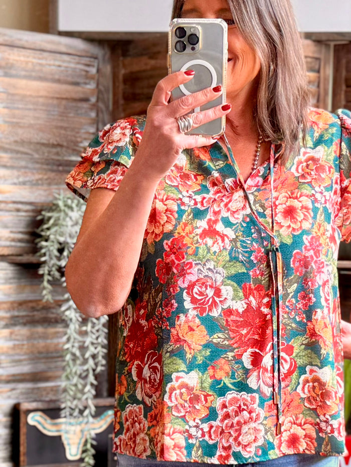 Floral flutter-sleeve shirt with teal base, V-neck and button front, multicolor roses