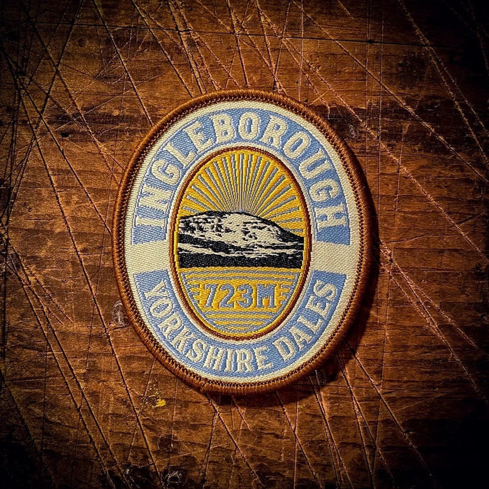 Forager Provisions LTD embroidered Ingleborough patch featuring a mountain peak design on a rustic wooden background.
