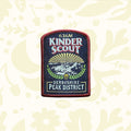 Kinder Scout Patch from The Adventure Patch Company’s Fells Series on rustic scratched wood; embroidered hiking badge.