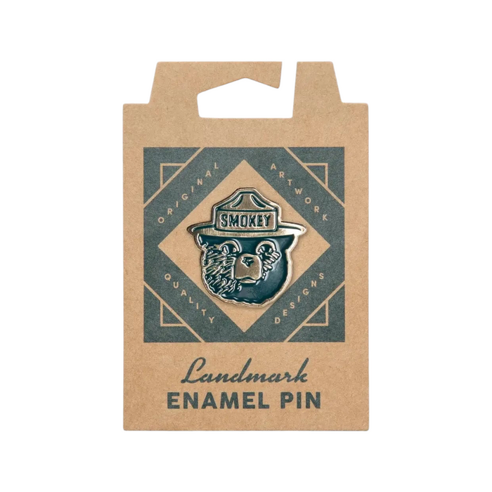 Smokey Bear enamel pin by The Landmark Project on geometric card—ideal for wildfire prevention supporters and collectors.