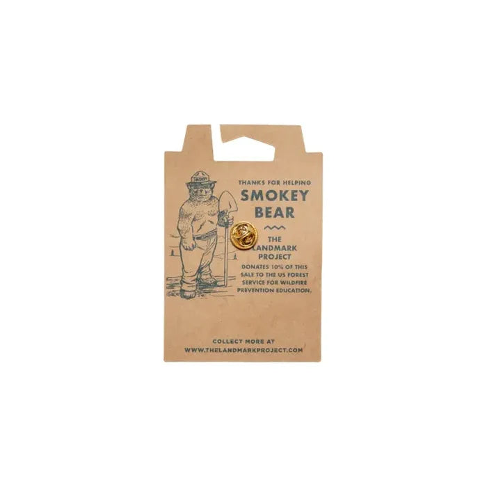 Landmark Project Smokey Bear Enamel Pin with Smokey logo, outdoor collectible on branded info card, perfect for fans.