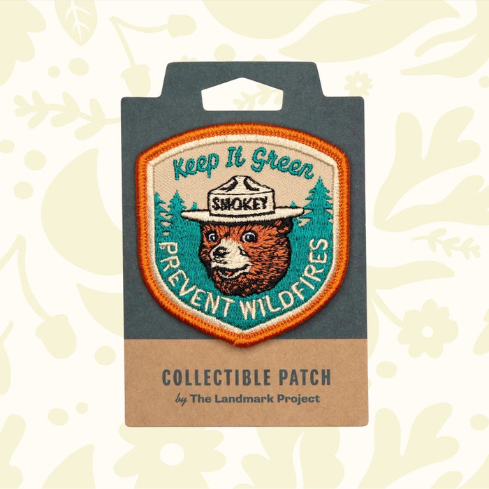 The Landmark Project Smokey Bear Patch - Keep It Green is a collectible patch featuring Smokey Bear in a hat, with the text "Keep It Green" and "Prevent Wildfires," endorsed by the USDA Forest Service for wildfire prevention.