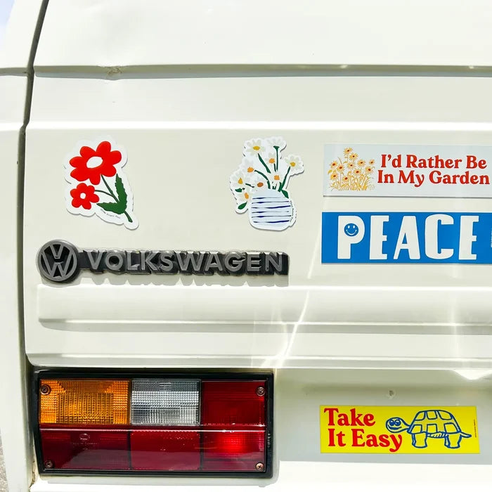 Close-up of a white van displaying Three Potato Four 3P4 Car Camper Van Magnets—Down To Earth travel decor by Three Potato Four.