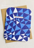A blue triangle print card with cutout window revealing red lettering reading "Best. Dad. Ever.".