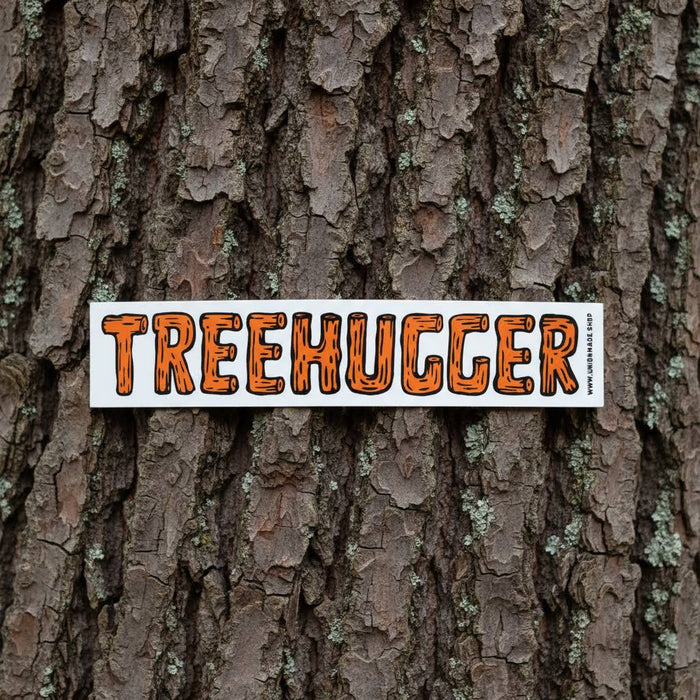 Forager Provisions LTD Tree Hugger vinyl sticker with orange textured lettering on a rough tree bark background