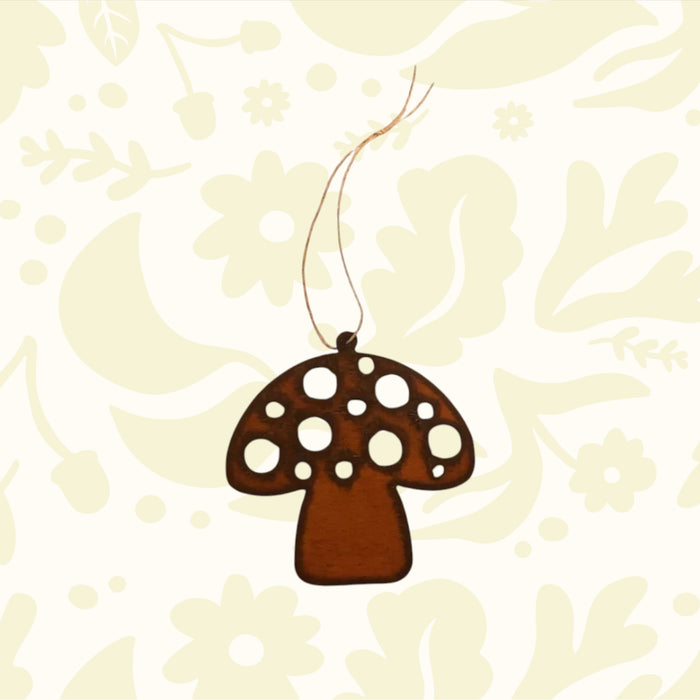 Universal Ironworks Redcap Mushroom Hanging Decoration suspended by string, displayed on white wooden background farmhouse decor.