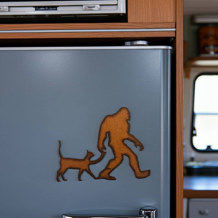 Forager Provisions LTD rustic steel Bigfoot with cat magnet attached to a grey refrigerator door