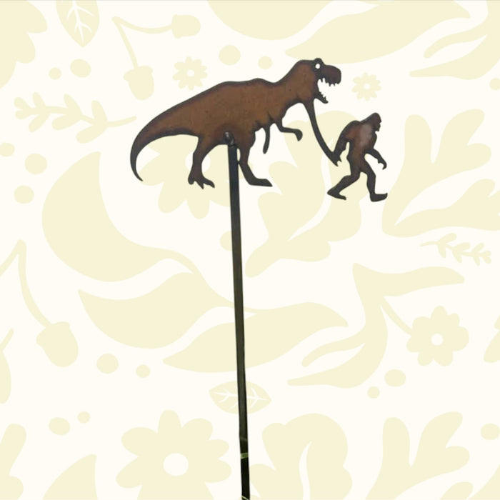 Forager Provisions LTD rustic steel plant stake featuring a silhouette of Bigfoot walking with a T-Rex dinosaur.