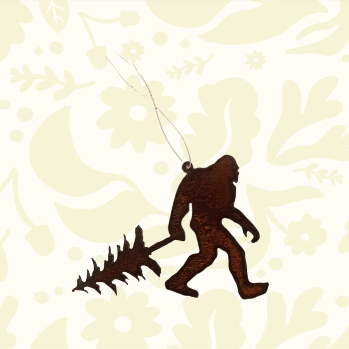 Handmade Bigfoot Yeti Walking With Tree metal ornament by Universal Ironworks, USA. Unique hanging decor, rustic woodland gift.