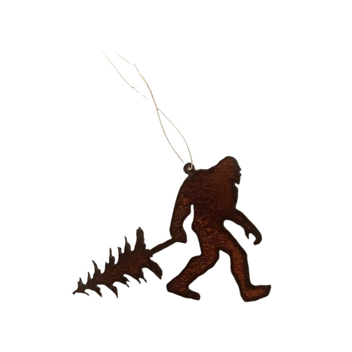 Forager Provisions LTD rustic metal Bigfoot ornament carrying a pine tree, handmade from hand-cut steel.
