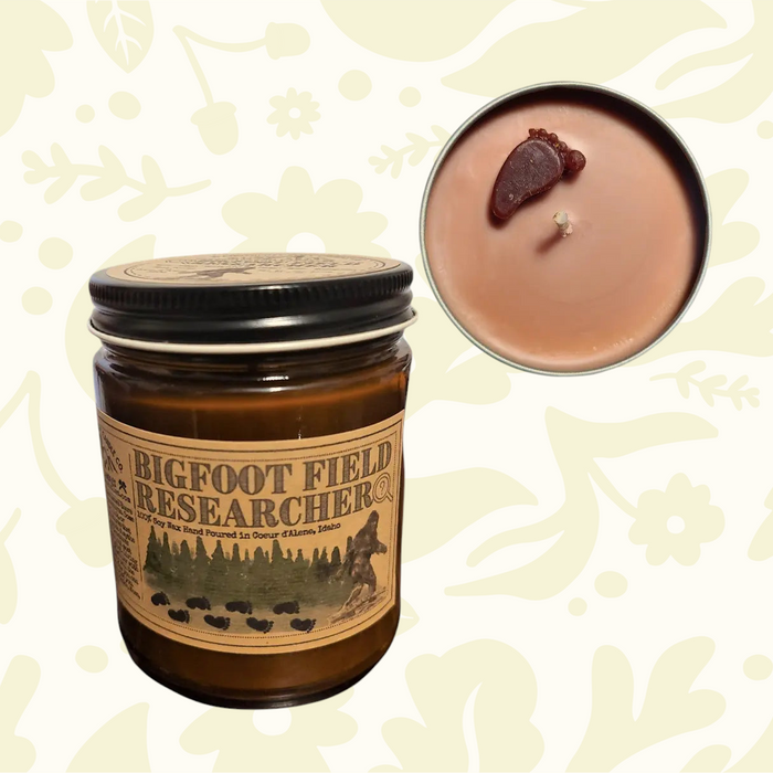 Forager Provisions LTD Bigfoot Field Researcher soy candle with a Sasquatch footprint wax topper in a glass jar.
