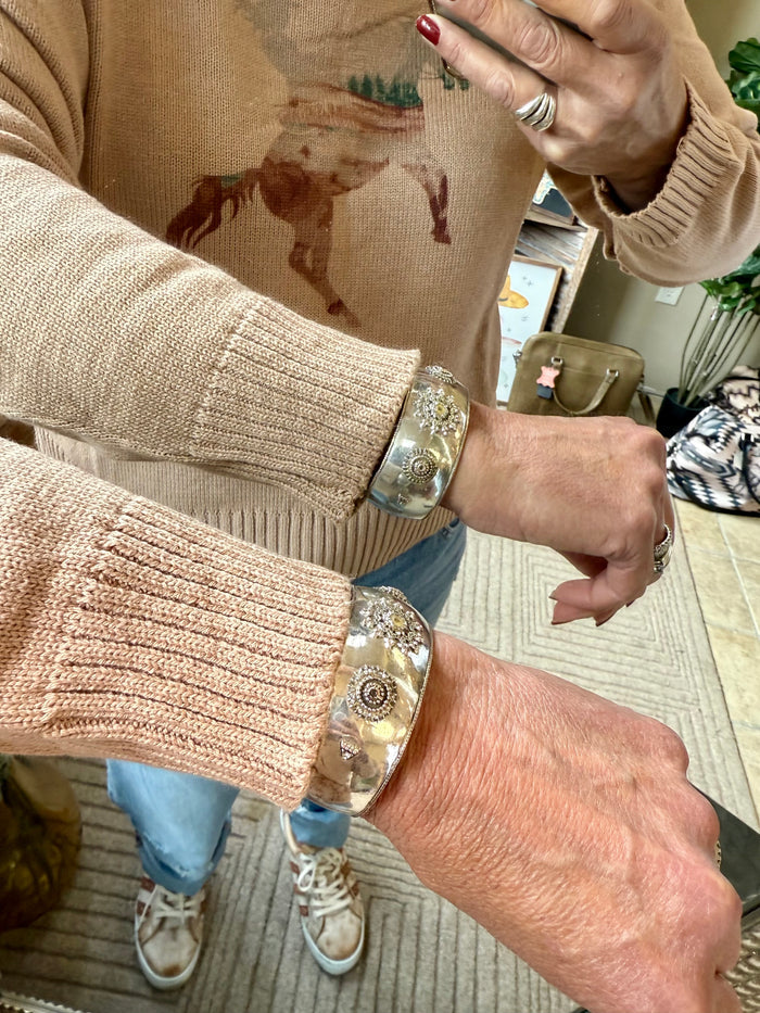 Light pink knit sweater sleeve with watercolor horse graphic and ribbed cuff