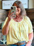 Yellow and white striped short-sleeve shirt with dotted accents and round gathered neckline